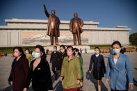 People leave after paying their respects before the statues of late North Korean leaders Kim Il Sung and Kim Jong Il at Mansu hill, as the country marks the 75th founding anniversary of the Workers' Party of Korea, in Pyongyang on October 10, 2020. (Photo by KIM Won Jin / AFP) / The erroneous mention[s] appearing in the metadata of this photo by Kim Won Jin has been modified in AFP systems in the following manner: [Kim Won Jin] instead of [Ed Jones]. Please immediately remove the erroneous mention[s] from all your online services and delete it (them) from your servers. If you have been authorized by AFP to distribute it (them) to third parties, please ensure that the same actions are carried out by them. Failure to promptly comply with these instructions will entail liability on your part for any continued or post notification usage. Therefore we thank you very much for all your attention and prompt action. We are sorry for the inconvenience this notification may cause and remain at your disposal for any further information you may require. (Photo by KIM WON JIN/AFP via Getty Images)