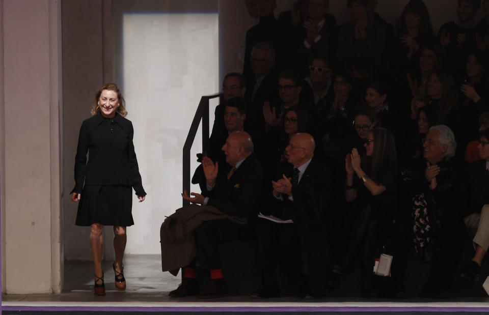 Italian fashion designer Miuccia Prada acknowledges applause at the end of the presentation of Prada women's Fall-Winter 2012-2013 collection in Milan, Italy, Thursday, Feb. 23, 2012. (AP Photo/Luca Bruno)