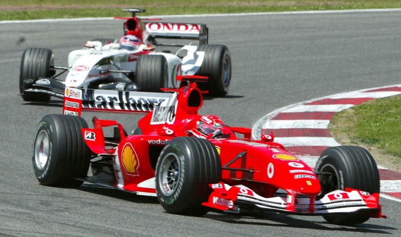 FILE PHOTO: Germany's Michael Schumacher leads Japan's Takuma Sato during the first lap of the Spanish Grand Prix in Barcelona.