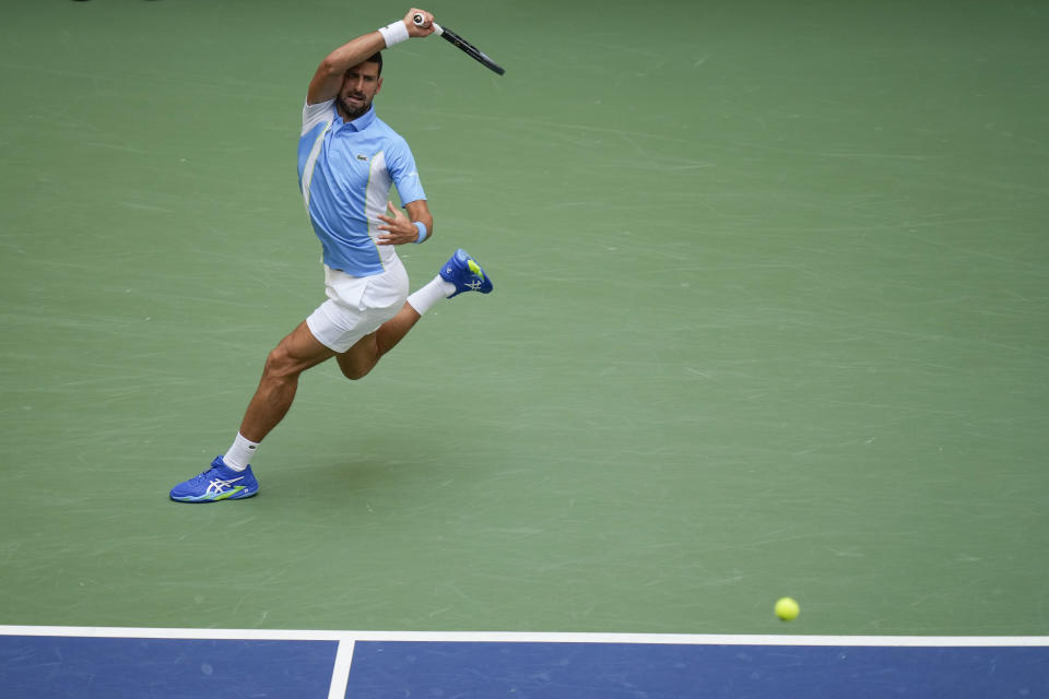 Novak Djokovic, of Serbia, returns a shot to Taylor Fritz, of the United States, during the quarterfinals of the U.S. Open tennis championships, Tuesday, Sept. 5, 2023, in New York. (AP Photo/Seth Wenig)