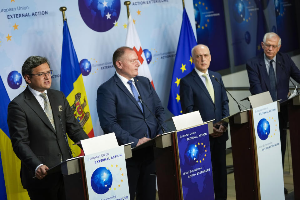 FILE - From left, Ukraine's Foreign Minister Dmytro Kuleba gives a joint statement next to his Moldova's counterpart Aureliu Ciocoi, Georgia's counterpart David Zalkaliani and European Union foreign policy chief Josep Borrell after their meeting at the EU headquarters in Brussels, on June 24, 2021. The war in Ukraine has put the European Union's expansion at the top of the agenda as officials from the Western Balkans and EU leaders gather Tuesday for a summit intended to reinvigorate the whole enlargement process. (AP Photo/Francisco Seco, Pool, File)