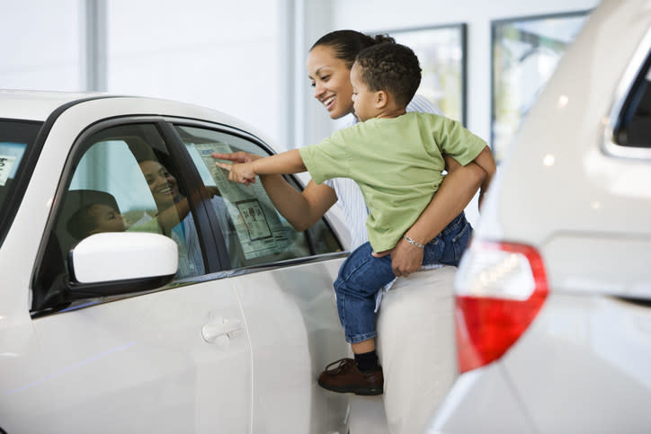 mom and young son car shopping