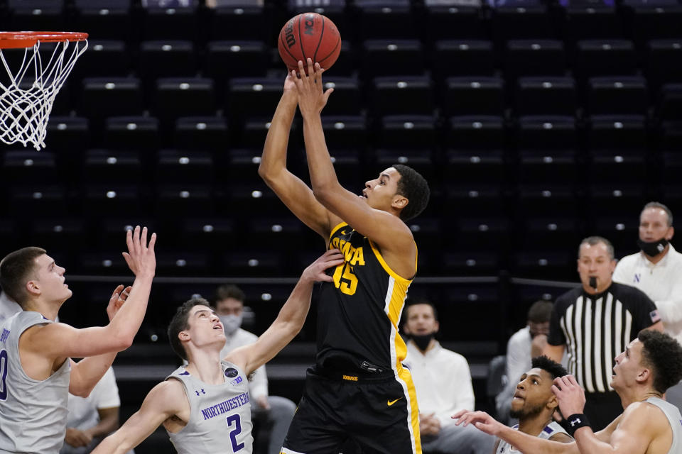 Iowa forward Keegan Murray, center, goes up for a shot against Northwestern during the first half of an NCAA college basketball game in Evanston, Ill., Sunday, Jan. 17, 2021. (AP Photo/Nam Y. Huh)