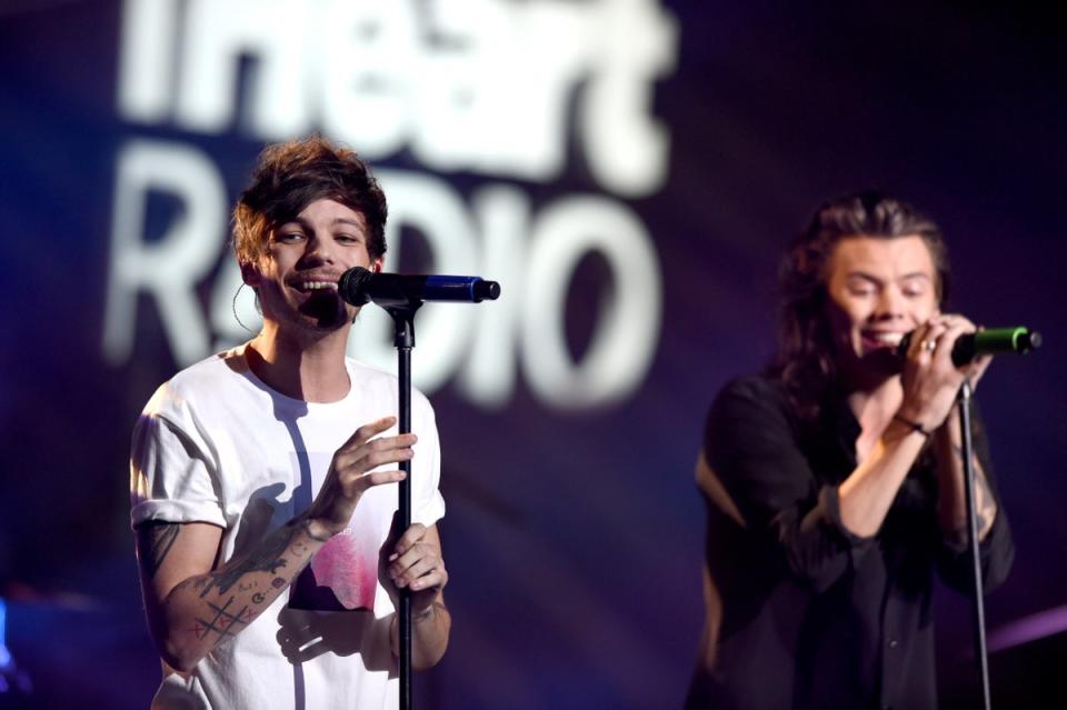 Tomlinson (L) and Styles onstage during  the Jingle Ball in Dllas, Texas in 2015 - a year before the group split (Getty)