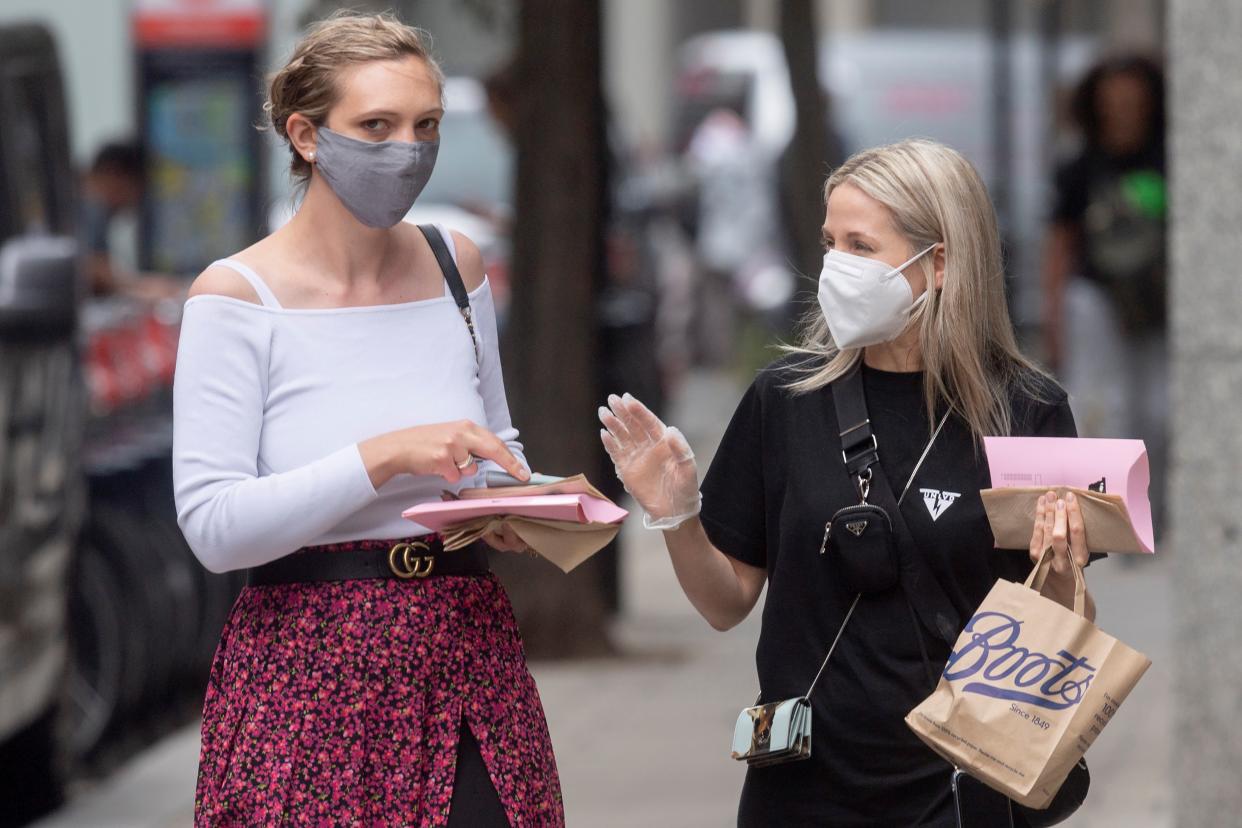 People wearing face masks talk on a street in London, Britain, on June 17, 2021. Britain has reported another 11,007 coronavirus cases in the latest 24-hour period, bringing the total number of coronavirus cases in the country to 4,600,623, according to official figures released Thursday. (Photo by Ray Tang/Xinhua via Getty Images)