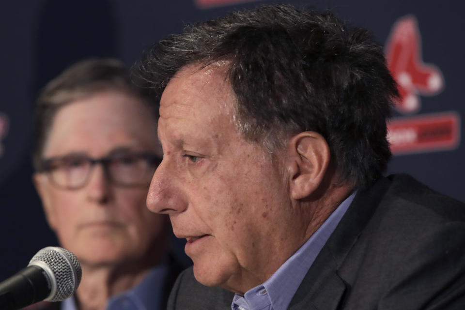 FILE - In this Jan. 15, 2020, file photo, Boston Red Sox baseball team owner John Henry, left, listens as chairman Tom Werner speaks during a news conference at Fenway Park in Boston. Liverpool won its first league title since 1990, clinching Thursday, June, 25, 2020. Because of the pandemic, Henry and Werner, who headed the group that bought the team in 2010, watched on television from the U.S. (AP Photo/Elise Amendola, File)