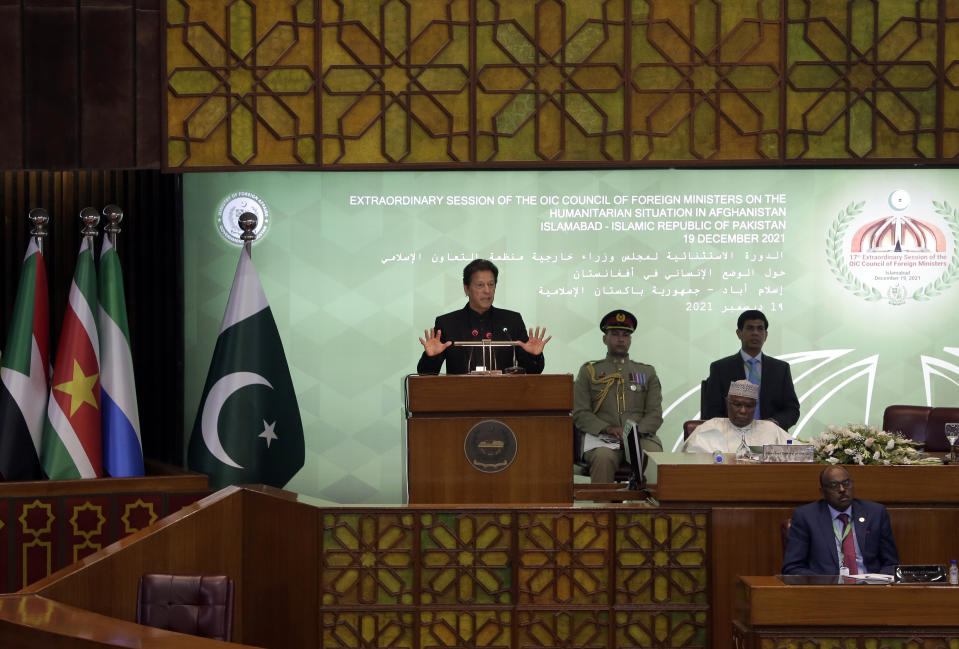 Pakistan Prime Minister Imran Khan, center, speaks during the 17th extraordinary session of Organization of Islamic Cooperation (OIC) Council of Foreign Ministers, in Islamabad, Pakistan, Sunday, Dec. 19, 2021. The economic collapse of Afghanistan, already teetering dangerously on the edge, would have a "horrendous" impact on the region and the world, successive speakers warned Sunday at the start of a one-day summit of foreign ministers. (AP Photo/Rahmat Gul)