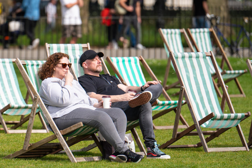 Two people rest on deck chairs in Hyde Park, as people enjoy the warm weather in London. Parts of the UK are enjoying warmer weather than usual on Easter Sunday as the spate of high temperatures continues. Picture date: Sunday April 17, 2022.