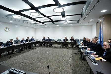 Syrian government delegation members (L) hold a meeting of Intra-Syria peace talks with UN Special Envoy for Syria Staffan de Mistura at Palais des Nations in Geneva, Switzerland, February 25, 2017. REUTERS/Pierre Albouy