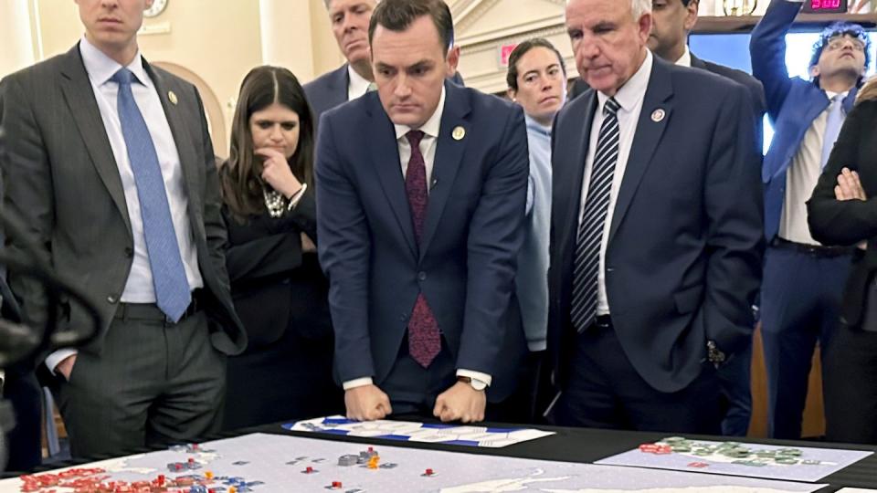 Lawmakers gather for a tabletop wargame in the House Ways and Means Committee room on April 19, 2023. (Ellen Knickmeyer/AP)