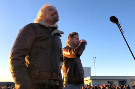 Richard Branson watches the take off of Virgin Galactic’s carrier airplane carrying a space tourism rocket plane toward space from Mojave Air and Space Port in Mojave, California,U.S. December 13, 2018. REUTERS/Eric Johnson