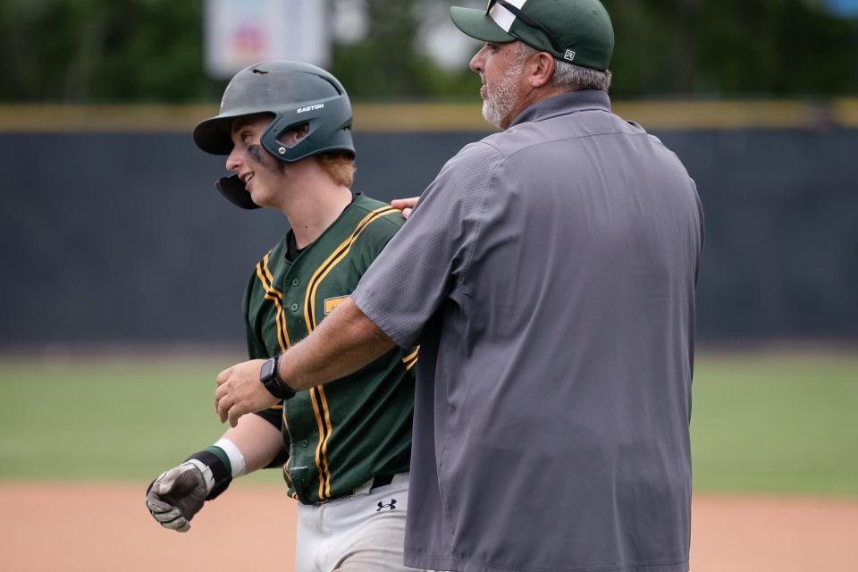 Tantasqua's Petey Casine, whose final at-bat  was caught in deep right field, is consoled by assistant coach and father Pete after the Warriors' 1-0 loss to St. Mary's in a Division 3 state semifinal.