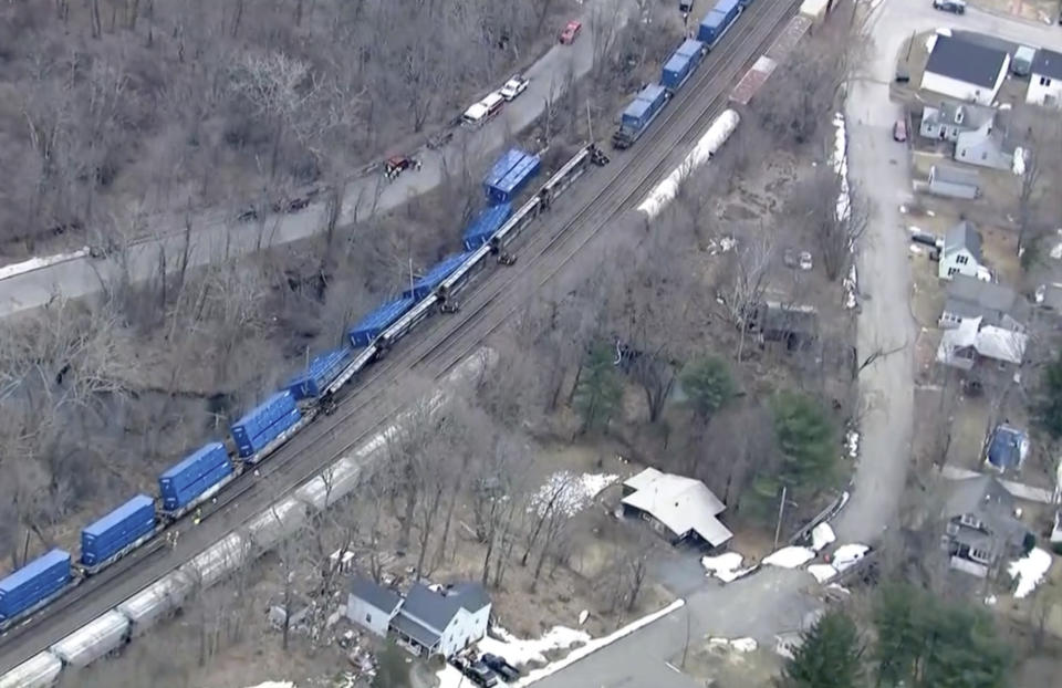 Trains cars lie on their sides after a freight train derailment, Thursday, March 23, 2023, in Ayer, Mass. No hazardous materials were being hauled, according to the local fire department. Video appeared to show Norfolk Southern engines hauling several railcars that had toppled off the tracks onto their sides. (WCVB frame grab via AP) BOSTON, NEW ENGLAND OUT