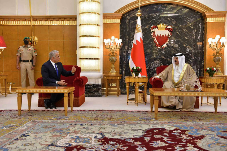 In this photo provided by the Israeli Government Press Office, Israel's Foreign Minister Yair Lapid, center left, walks with Bahraini King Hamid bin Issa al Khalifa, during the first high-level visit to the small Gulf state by a senior Israeli official since the signing of a landmark agreement to establish diplomatic ties between the two countries last year, in Manama, Bahrain, Thursday, Sept. 30, 2021. Lapid will inaugurate Israel’s embassy. (Shlomi Amshalem/GPO via AP)