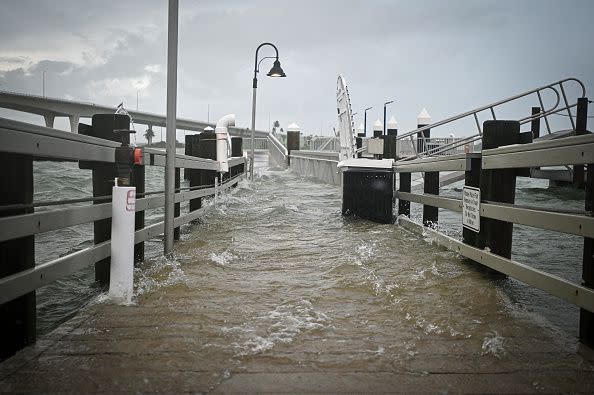 TOPSHOT - A boardwalk at the Clearwater Harbor Marina in Clearwater, Florida, is flooded by the rising tide on August 30, 2023, after Hurricane Idalia made landfall. Idalia barreled into the northwest Florida coast as a powerful Category 3 hurricane on Wednesday morning, the US National Hurricane Center said. 