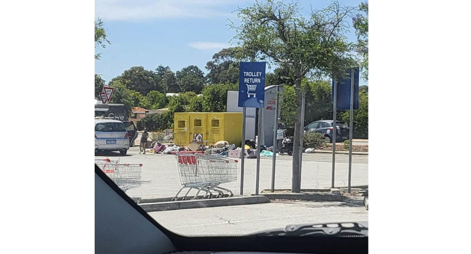 Piles of donations in front of three Good Sammy charity bins at Kardinya Park shopping centre.