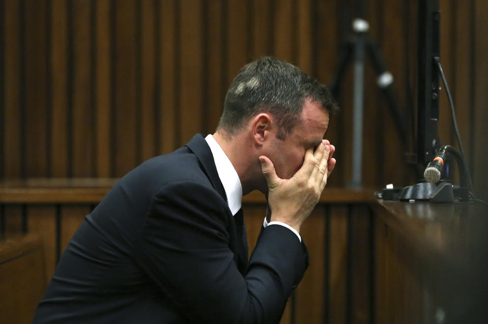 Oscar Pistorius listens to ballistic evidence being given in court in Pretoria, South Africa, Wednesday, March 19, 2014. Pistorius is on trial for the murder of his girlfriend Reeva Steenkamp on Valentine's Day in 2013. (AP Photo/Themba Hadebe, Pool)