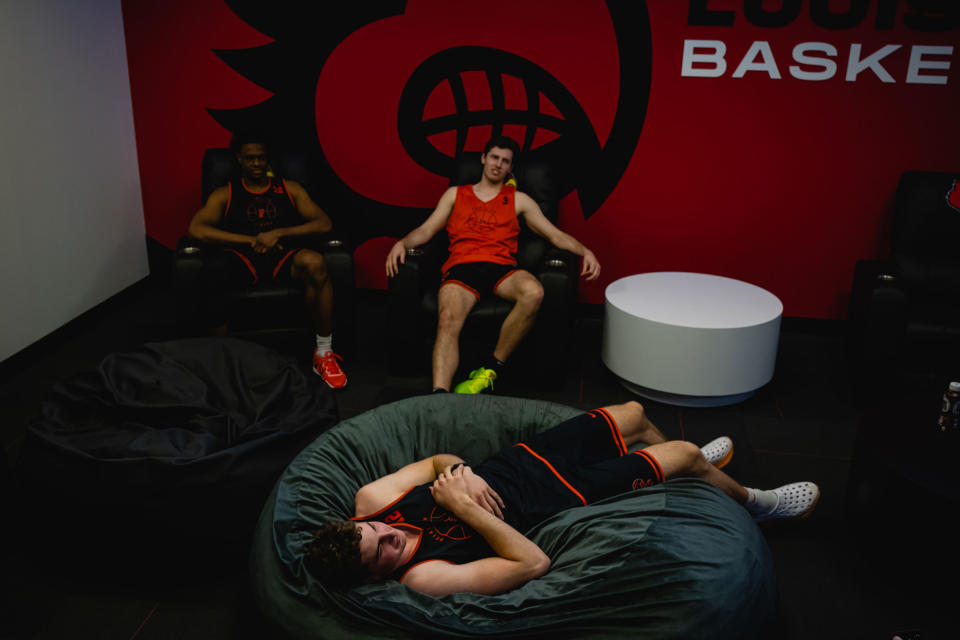 Keeshawn Kellman, Ryan Langborg, and Caden Pierce relax in a players’ lounge at the KFC Yum! Center.<span class="copyright">Jon Cherry for TIME</span>