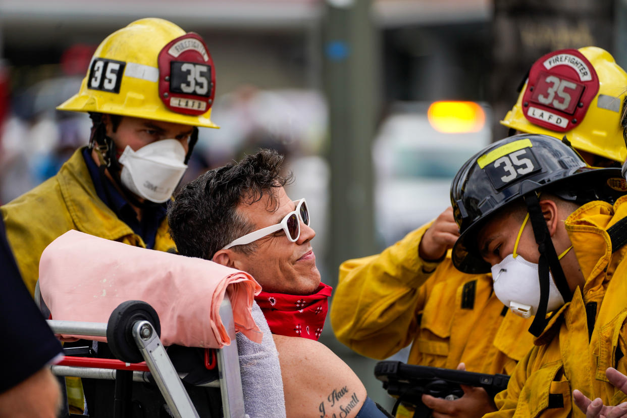 Actor Steve-O is checked out by fire fighters after being brought down a Hollywood billboard in August 2020