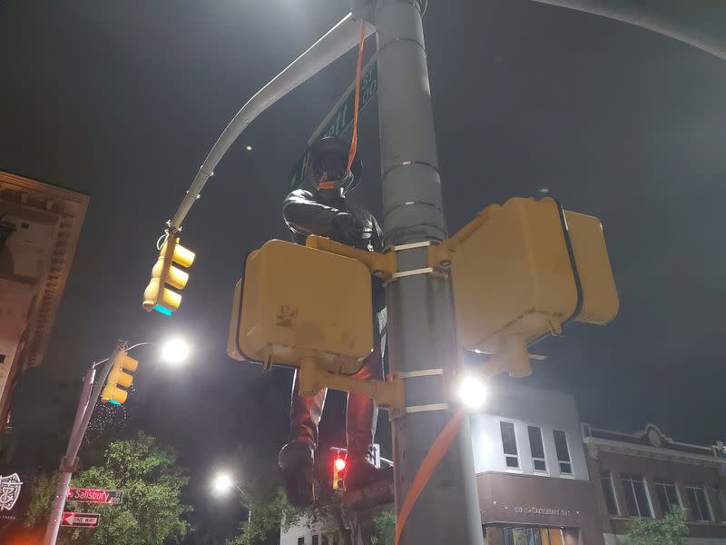 A Confederate statue is seen hanging on a street post in Raleigh