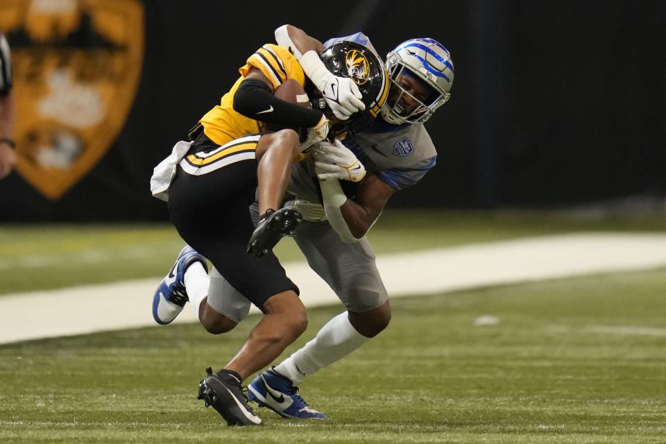 Missouri defensive back Kris Abrams-Draine, left, intercepts a pass intended for Memphis wide receiver Tauskie Dove during the second half of an NCAA college football game Saturday, Sept. 23, 2023, in St. Louis. (AP Photo/Jeff Roberson)