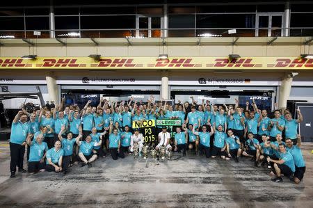 Mercedes Formula One driver Lewis Hamilton of Britain celebrates winning the Bahrain Grand Prix with driver Nico Rosberg and the team in Sakhir April 19, 2015. Action Images via Reuters / Hoch Zwei