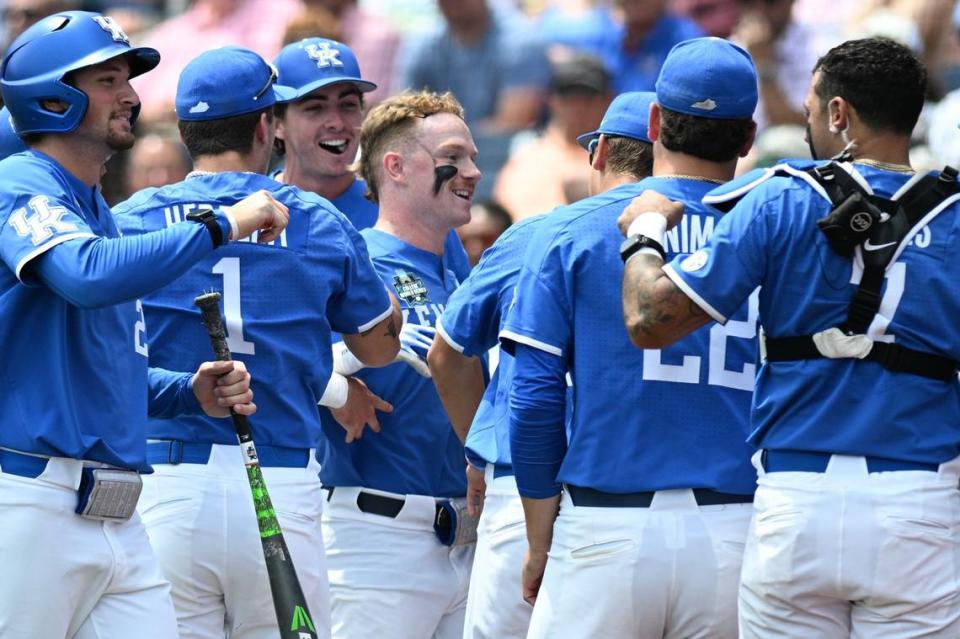 Jun 15, 2024; Omaha, NE, USA; Kentucky Wildcats center fielder Nolan McCarthy (19) celebrates with the team after hitting a home run against the NC State Wolfpack during the fourth inning at Charles Schwab Filed Omaha. Mandatory Credit: Steven Branscombe-USA TODAY Sports