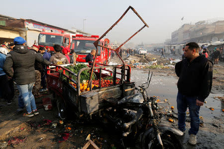 People gather at the site of a car bomb attack at a vegetable market in eastern Baghdad, Iraq January 8, 2017. REUTERS/Wissm al-Okili