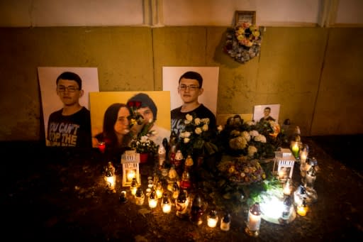 A picture taken in Bratislava on February 20, 2019 shows candles beside portraits of Slovakian journalist Jan Kuciak and his fiancee Martina Kusnirova who were found shot dead at the couple's home near Bratislava