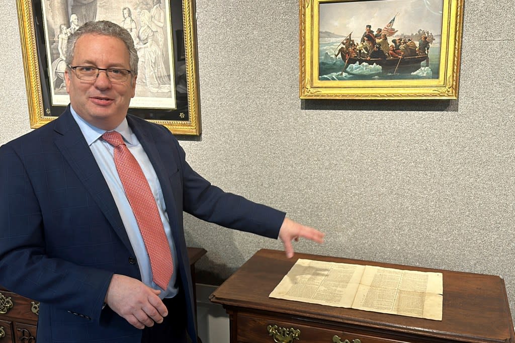 Historian Seth Kaller shows off a 1787 copy of the U.S. Constitution that will be put up for auction. AP