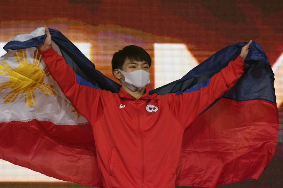 Carlos Edriel Yulo, of the Philippines, poses during the victory ceremony for the the vault final in the FIG Artistic Gymnastics World Championships in Kitakyushu, western Japan, Sunday, Oct. 24, 2021. (AP Photo/Hiro Komae)