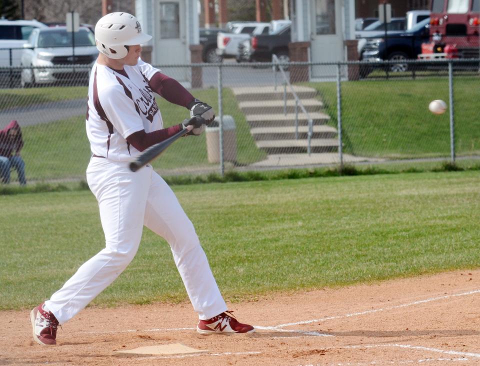 Charlevoix's Jake Claflin sees a pitch he likes and swings into it during Thursday's game.