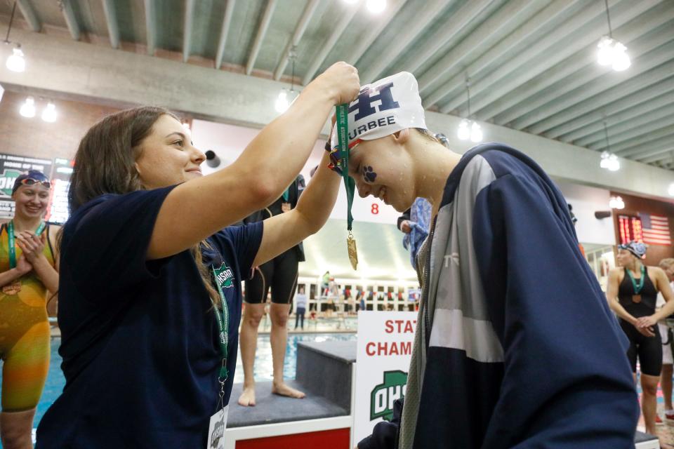 Grandview Heights’ Carrie Furbee receives her first-place medal for winning the 100-yard freestyle during the Division II state swimming meet Friday at Branin Natatorium in Canton. Furbee also won the 50 free.
