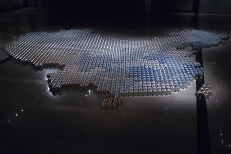 An installation titled "Baby Formula" made from 1,815 cans of milkpowder by China's dissident artist Ai Weiwei is displayed at "A Journal of the Plague Year. Fear, ghosts, rebels. SARS, Leslie and the Hong Kong story" exhibition in Hong Kong in this May 16, 2013 file photo. REUTERS/Tyrone Siu/Files