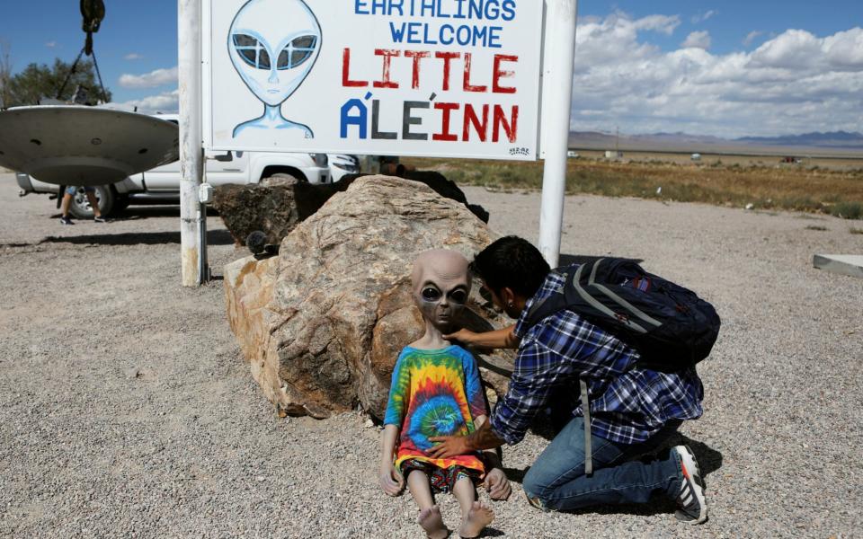 A visitor poses a doll at Area 51, a secretive US military base believed by UFO enthusiasts to hold government secrets about extra-terrestrials - JIM URQUHART /REUTERS