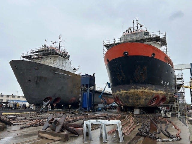 Two offshore supply vessels undergoing refurbishment to be ferries for the Woods Hole, Martha's Vineyard and Nantucket Steamship Authority sit in a dry dock in an Alabama shipyard.