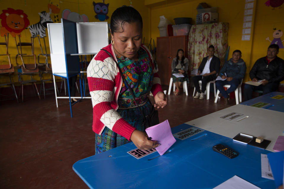 A indigenous woman casts her votes at a polling station in Sumpango, Guatemala, Sunday, June 16, 2019. Guatemalans vote for their next president Sunday in elections plagued by widespread disillusion and distrust, and as thousands of their compatriots flee poverty and gang violence to seek a new life in the United States. (AP Photo/Moises Castillo)