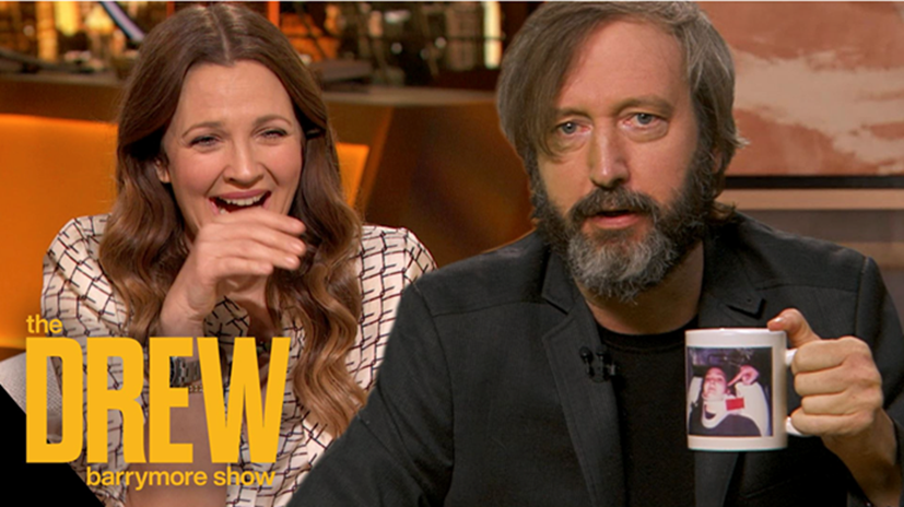 Tom Green surprises Drew Barrymore with his 20-year-old keepsake from their relationship: a mug featuring a photo of Barrymore in a neck brace.