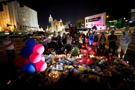 FILE PHOTO: People gather at a makeshift memorial in the middle of Las Vegas Boulevard following the mass shooting in Las Vegas, Nevada, U.S., October 4, 2017. REUTERS/Chris Wattie/File Photo