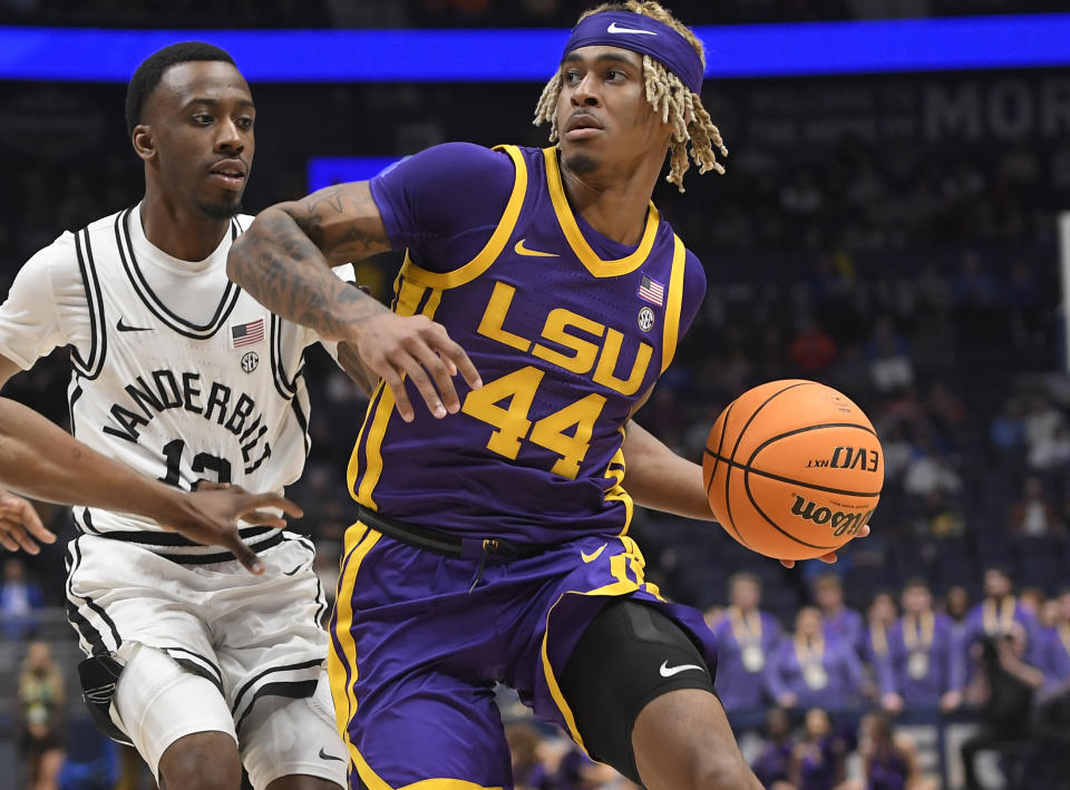 Mar 9, 2023; Nashville, TN, USA; LSU Tigers guard Adam Miller (44) drives past <a class="link " href="https://sports.yahoo.com/ncaab/teams/vanderbilt/" data-i13n="sec:content-canvas;subsec:anchor_text;elm:context_link" data-ylk="slk:Vanderbilt Commodores;sec:content-canvas;subsec:anchor_text;elm:context_link;itc:0">Vanderbilt Commodores</a> guard Trey Thomas (12) during the first half at Bridgestone Arena. Mandatory Credit: Steve Roberts-USA TODAY Sports