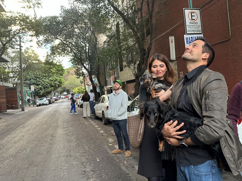 FILE PHOTO:People wait outside their homes and buildings in Mexico City