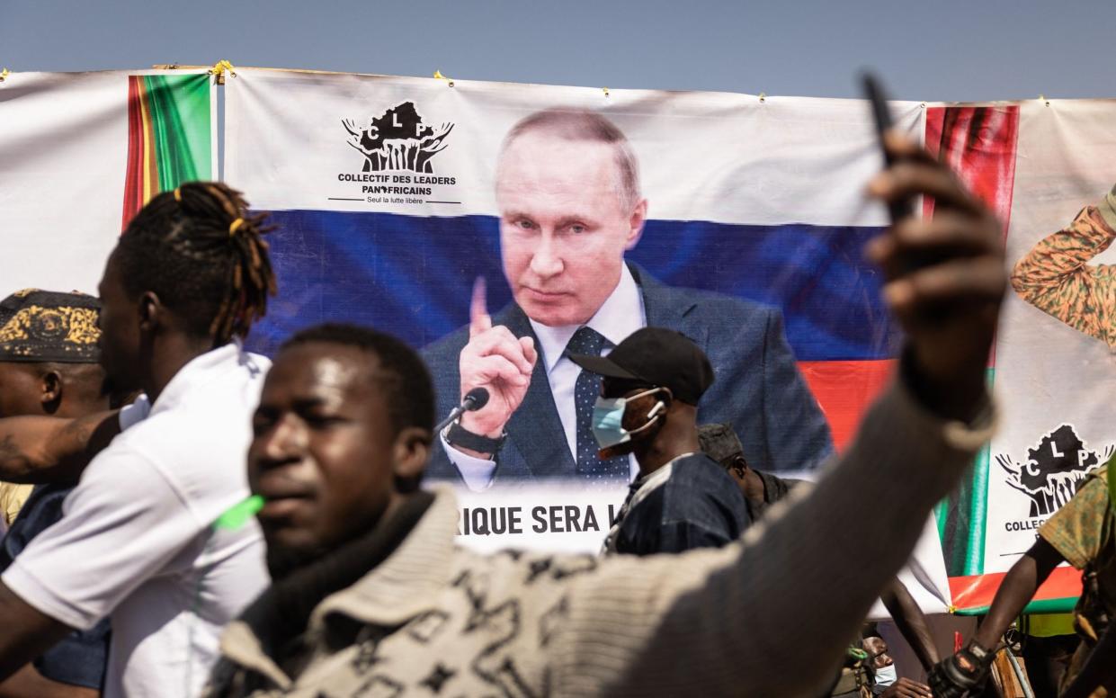 A banner of Vladimir Putin is seen during a protest to support President Ibrahim Traoré and to demand the departure of France's ambassador and military forces, in Burkina Faso, Jan 2023 - Olympia de Maismont/Getty