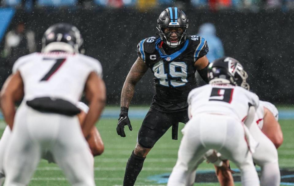 Pantherslinebacker Frankie Luvu (49) eyes the Falcons’ quarterback before the snap during the game at Bank of America Stadium on Sunday, December 16, 2023.