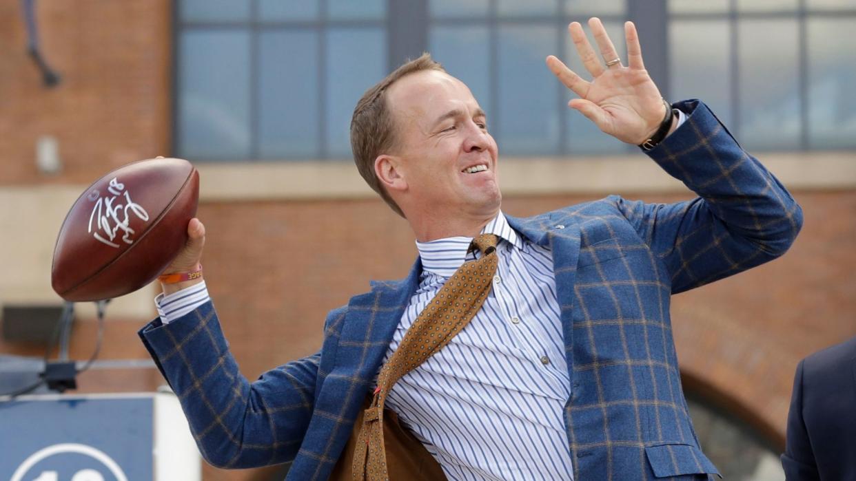 Mandatory Credit: Photo by AP/Shutterstock (9122615o)Former Indianapolis Colts quarterback Peyton Manning throws footballs to fans following the unveiling of a statue of himself outside of Lucas Oil Stadium, in IndianapolisColts Manning Statue Football, Indianapolis, USA - 07 Oct 2017.