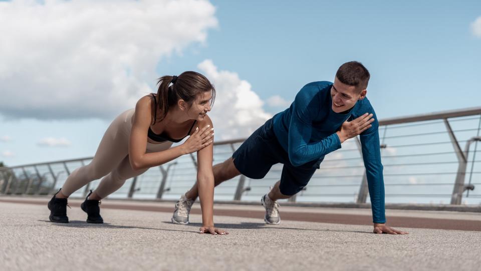 a photo of a couple doing plank shoulder taps