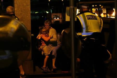 People flee as police attend to an incident near London Bridge in London, Britain, June 4, 2017. REUTERS/Neil Hall TPX IMAGES OF THE DAY