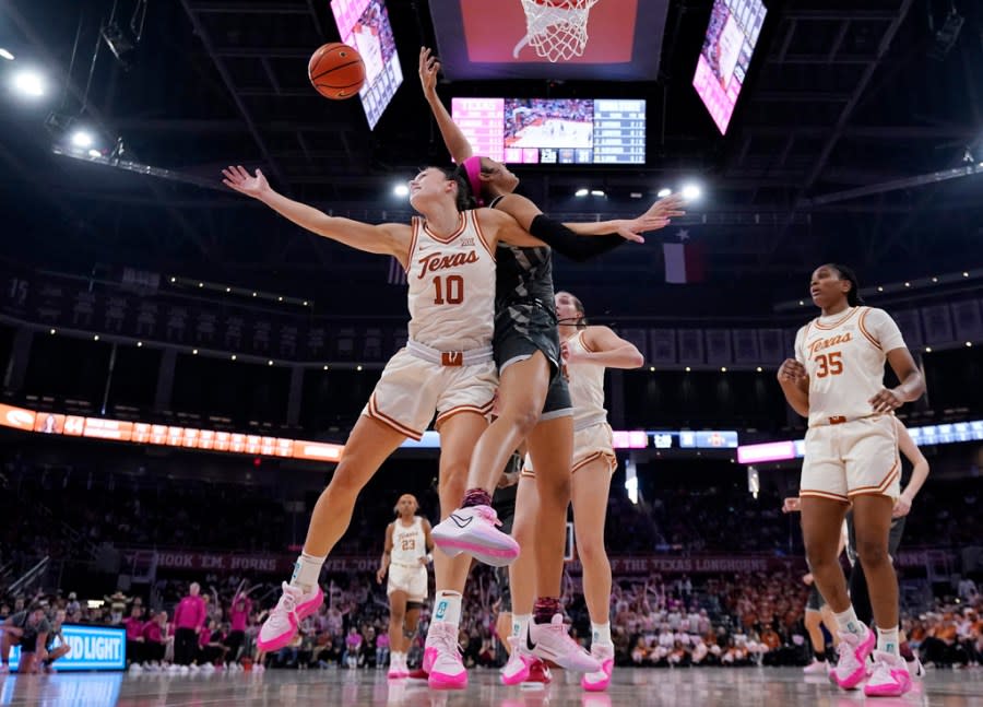 Texas guard Shay Holle (10) and Iowa State forward Jalynn Bristow, center right, battle for a rebound during the first half of an NCAA college basketball game in Austin, Texas, Saturday, Feb. 17, 2024. (AP Photo/Eric Gay)