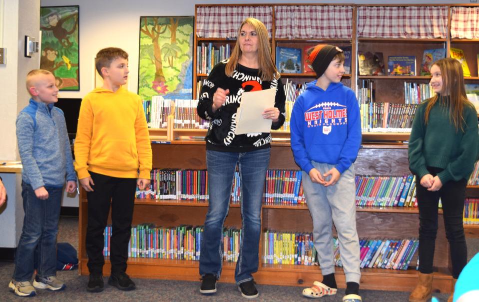 Oliver Ertle, left, Lincoln Day, Jacoby Rice and Jolie Dreher received recognition from the Millersburg Elementary School principal at the West Holmes School Board meeting Monday.