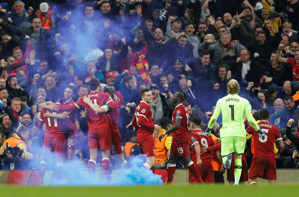 <p>Soccer Football – Champions League Quarter Final Second Leg – Manchester City vs Liverpool – Etihad Stadium, Manchester, Britain – April 10, 2018 Liverpool’s Mohamed Salah celebrates scoring their first goal with team mates as smoke grenade is on the pitch REUTERS/Darren Staples </p>