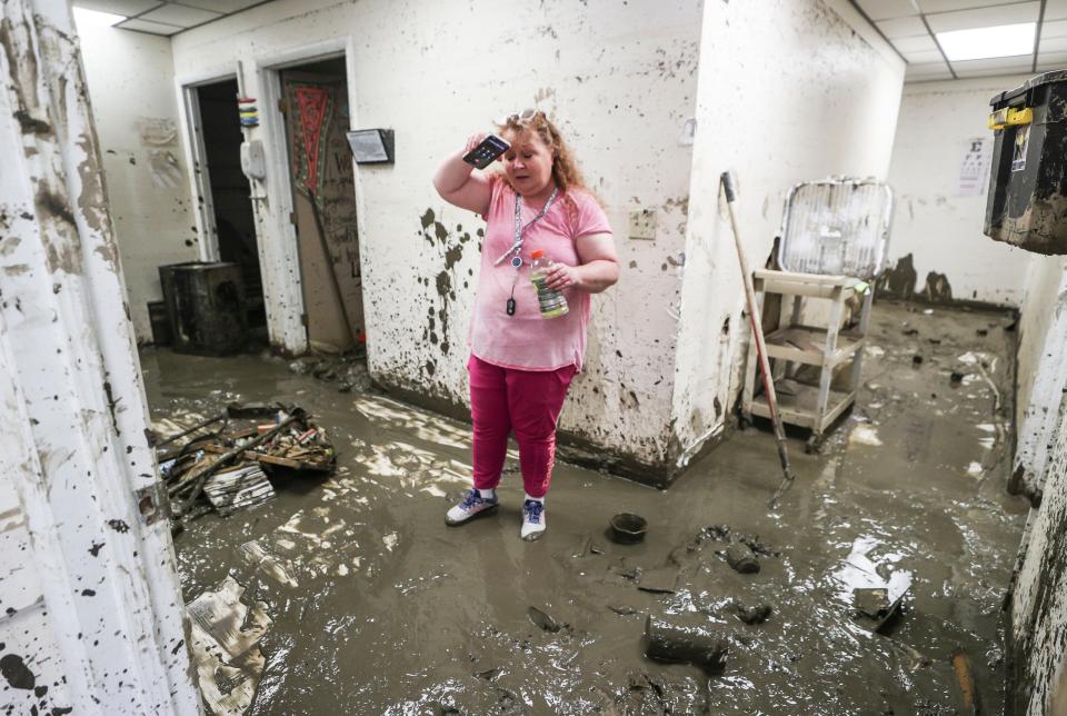 Dr. Brenda Baker talks with an insurance company inside the muddy remains of her medical practice in the tiny town of Neon, Ky. "We've lost everything," Baker said, who has been treating patients in the Fleming-Neon Middle School since the recent devastating floods. "She's our Dr. Quinn medical woman," said her assistant Bonita Robinson. Baker said she lost all her medical equipment -- some which cost more than $60,000 -- to the nine-feet high waters which filled her medical practice.